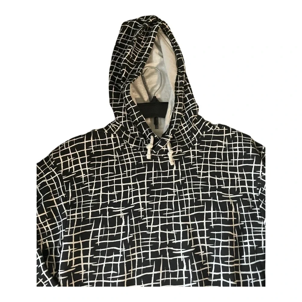 𝅺CRISTINA MARTINEZ GENDER INCLUSIVE GRAPHIC FLEECE HOODIE IN BLACK LADDE…